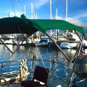 This green bimini matches the dodger on this boat. We made it out of 1 ¼” tubing to accommodate solar panels and also hold the grill on the side.. Aft Deck Bimini Top