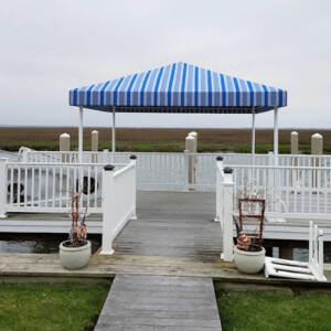 Compass Canvas not only specializes in the marine application of canvas, but we can craft anything that has to do with custom sewing using a needle and thread; like this deck awning. Deck Awning