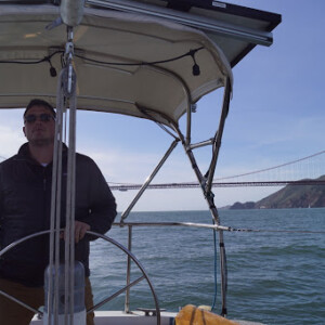 Compass Canvas Owner, Nick, enjoying the protection from the sun under the custom bimini he made for his Ericson 35 Ericson 35 Bimini