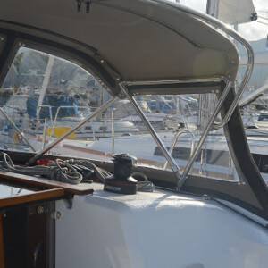 This dodger has a track and zipper system where the windows connect to the deck. This is a very watertight seal, and looks clean. Jeneau 34 Dodger - Track and Zipper