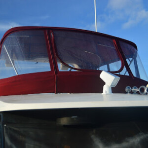 The old canvas on this boat was worn and the windows were damaged. This new enclosure is watertight with crystal clear windows McKinna Enclosure